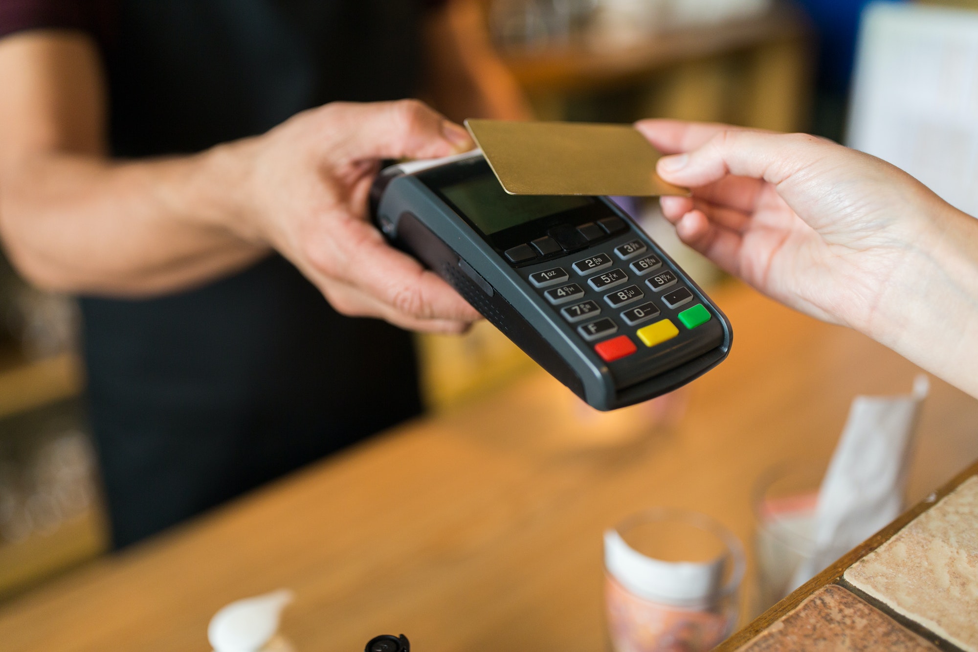 hands with payment terminal and credit card